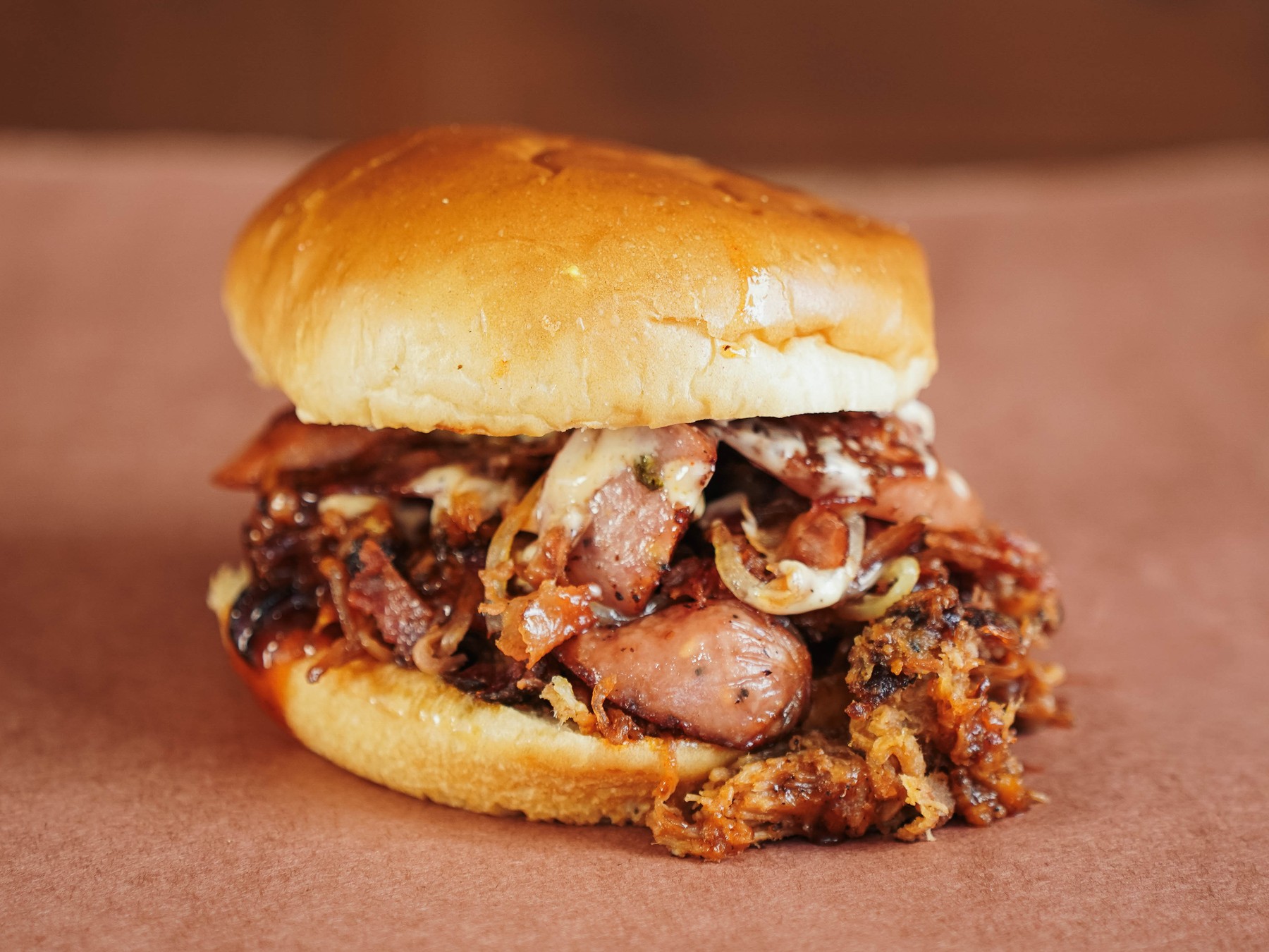 Alabama-Slamma — Pulled pork, bacon, smoked sausage, caramelized onions, Bama sauce.